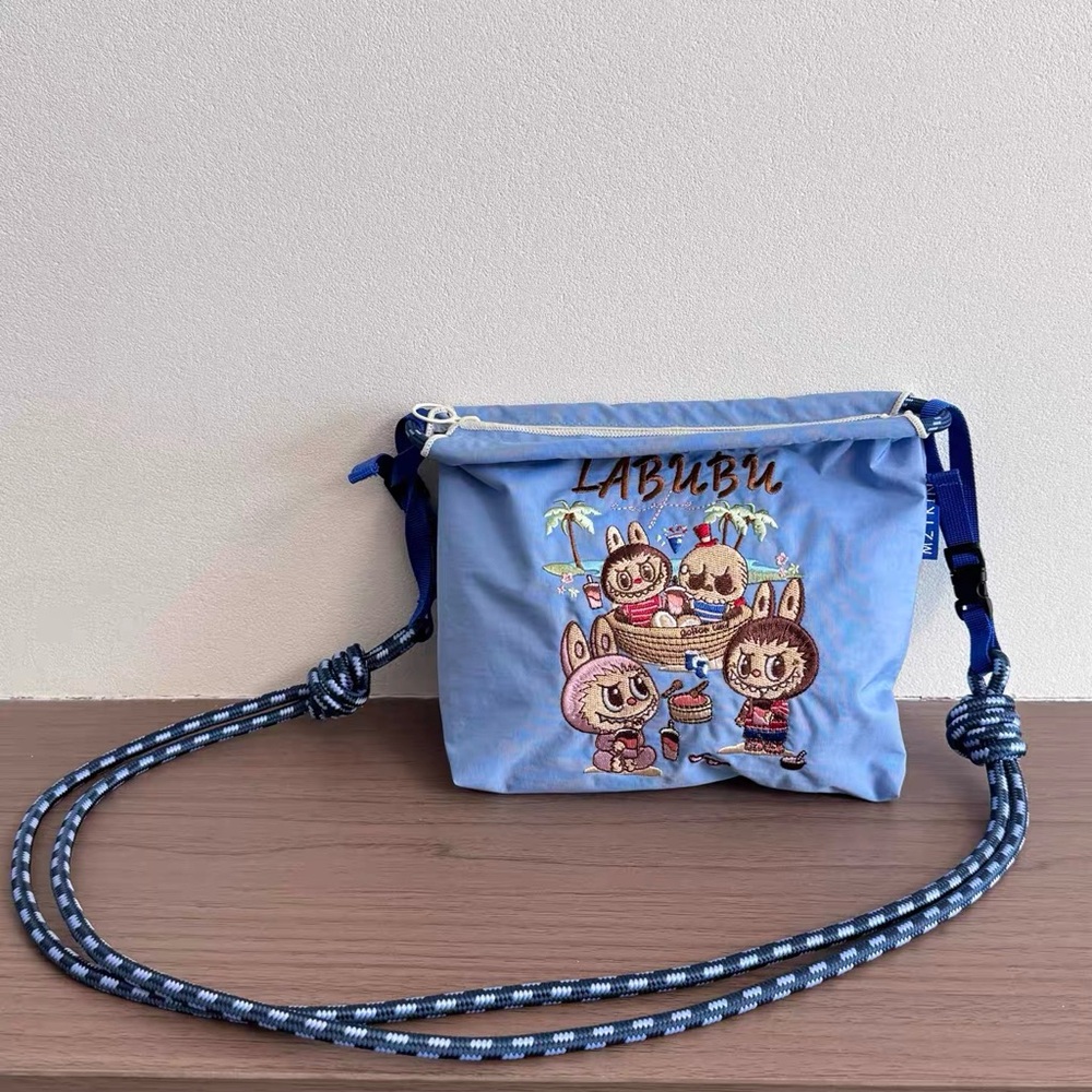 Labubu and friend at beach embroidered crossbody small Bag in blue
